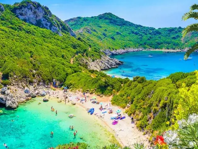 Vibrant beach scene with colorful umbrellas and people enjoying the sunny weather