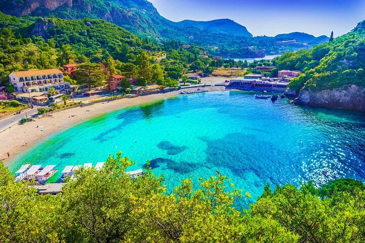 Breathtaking view of a vibrant bay with clear blue waters surrounded by greenery